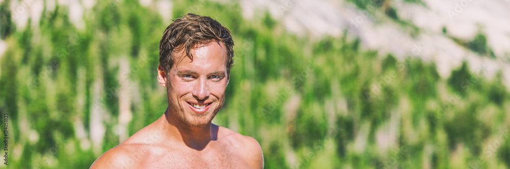 Summer outdoor lifestyle young man topless at forest lake with green trees background panorama banner portrait. Guy smiling in his 20s. Summer outdoor lifestyle young man topless at forest lake with green trees background panorama banner portrait. Guy smiling in his 20s.