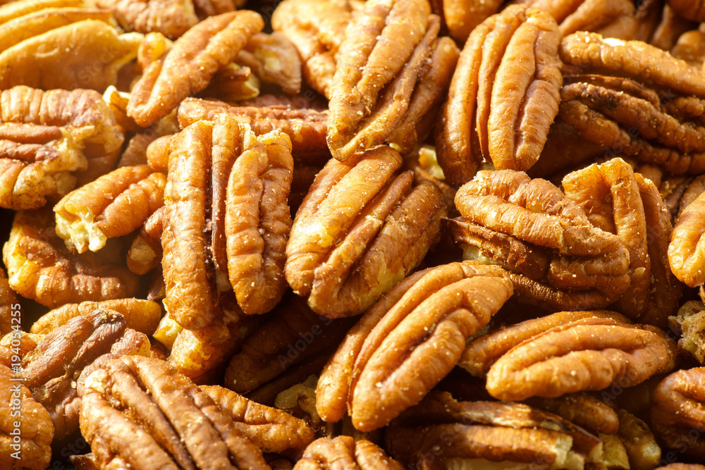 Pecans nuts. A close-up photograph. Unrefined whole kernel Pecans nuts. A close-up photograph. Unrefined whole kernel