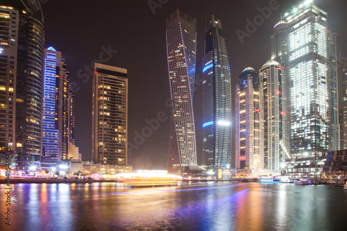 DUBAI  UAE - FEBRUARY 2018  Colorful evening on canal and promenade in Dubai Marina Dubai United Arab Emirates