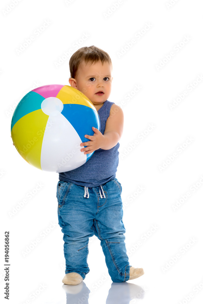 A little boy is playing with a ball. A little boy is playing with a ball.