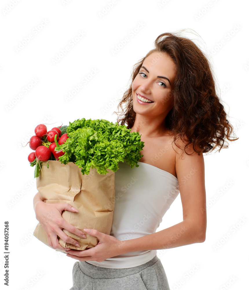 Young woman holding grocery paper shopping bag full of fresh vegetables. Diet healthy eating concept Young woman holding grocery paper shopping bag full of fresh vegetables. Diet healthy eating concept