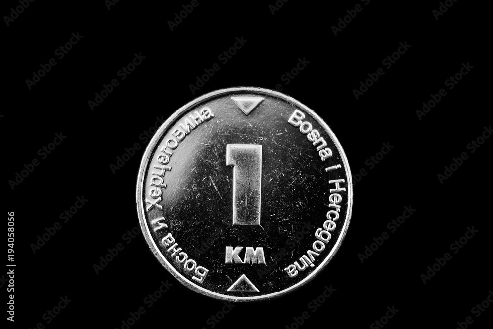 A macro image of a Bosnian 1 convertible mark coin isolated on a black background A macro image of a Bosnian 1 convertible mark coin isolated on a black background