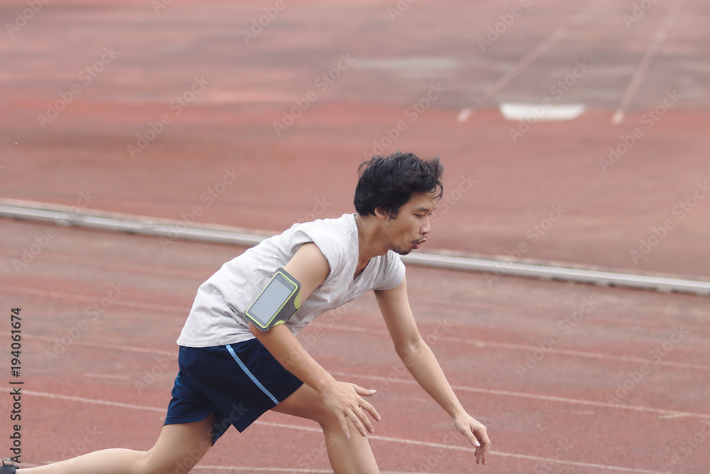 Young Asian runner injury and lying down on track during running. Accident sport concept.