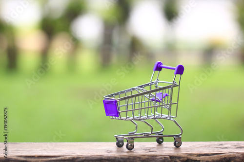 Wallpaper Mural Model miniature shopping cart on green background, Shopping online concept Torontodigital.ca