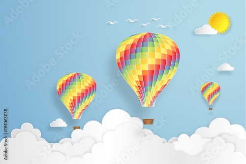 Fototapeta Naklejka Na Ścianę i Meble -  Colorful hot air balloon flying under blue sky and sunny as paper art, craft style concept. vector illustration.