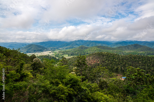 Mountains range view behind the mist of forest and tree, Northern of Thailand in Winter