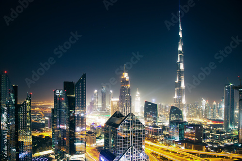 DUBAI  UAE - FEBRUARY 2018  Dubai skyline at sunset with Burj Khalifa  the world tallest building and Sheikh Zayed road traffic
