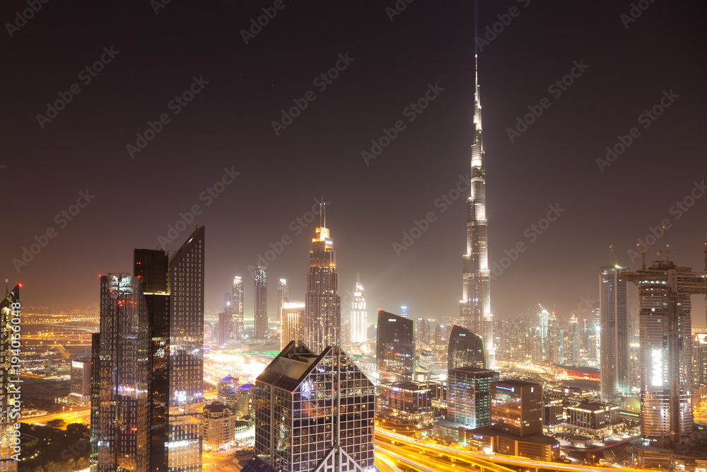 Fototapeta premium DUBAI, UAE - FEBRUARY 2018: Dubai skyline at sunset with Burj Khalifa, the world tallest building and Sheikh Zayed road traffic