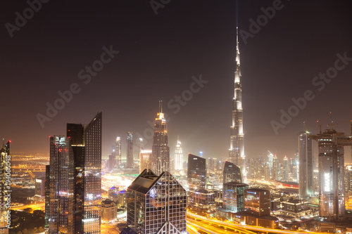 DUBAI  UAE - FEBRUARY 2018  Dubai skyline at sunset with Burj Khalifa  the world tallest building and Sheikh Zayed road traffic