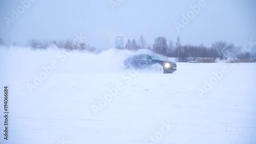 Sliding on an ice line. Snow drifting. DRIVING IN THE SNOW. Sport car racing on snow race track in winter. Driving a race car on a snowy road. photo