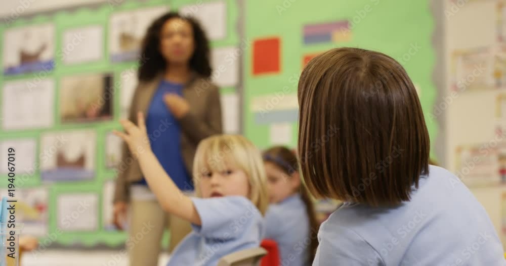 4K Elementary school teacher talking to class of young children & asking questions. Slow motion 4K Elementary school teacher talking to class of young children & asking questions. Slow motion