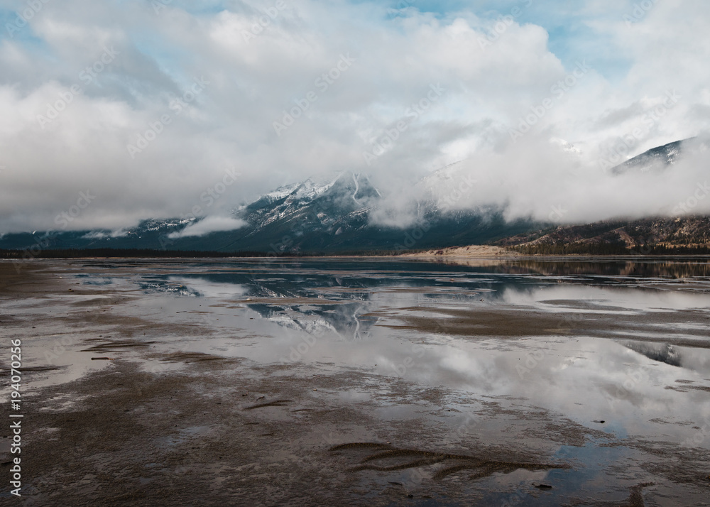 Reflective flooded fields show the Canadian Rockies of Jasper National Park