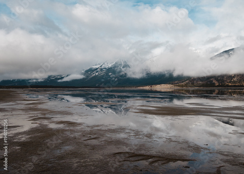 Reflective flooded fields show the Canadian Rockies of Jasper National Park