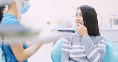 Dentist explaining the implant tooth to the patient