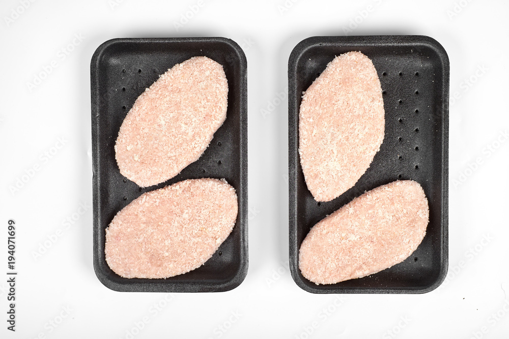 raw delicious chicken cutlet in package. Isolated on a white background. raw delicious chicken cutlet in package. Isolated on a white background.
