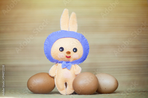 Easter rabbittoy with brown eggs in the chaff background photo