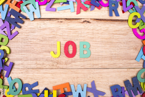 colorful wooden letter of the alphabet and the word JOB isolated on wood background