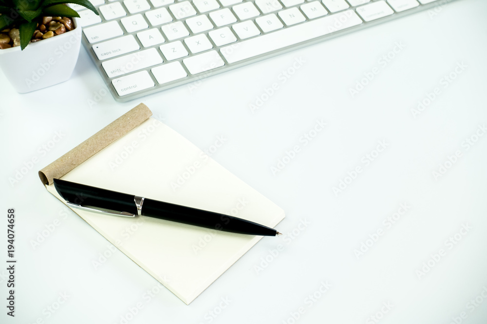 Modern White office desk table with pen and notebook,cup of coffee. Top view with copy space.Working desk table concept. Modern White office desk table with pen and notebook,cup of coffee. Top view with copy space.Working desk table concept.