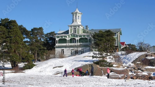 Children play on the rocks in the sunny february day. Hanko, Finland photo