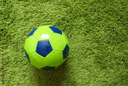 Football  Soccer  ball on a green surface imitating artificial grass. Sports photography 