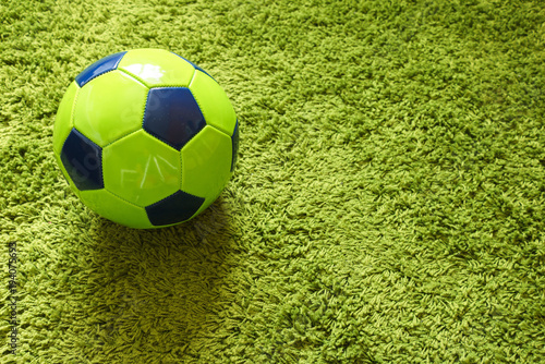 Football  Soccer  ball on a green surface imitating artificial grass. Sports photography 