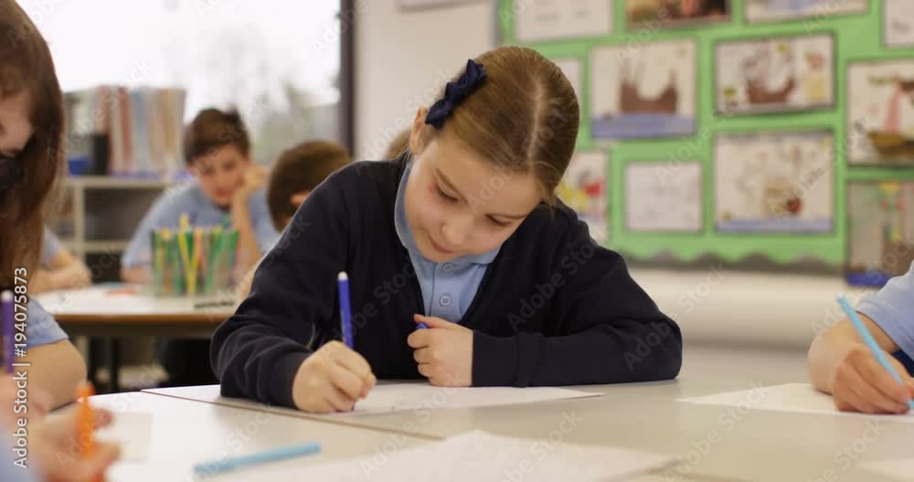 4K Happy elementary school children drawing at communal tables in classroom. Slow motion 4K Happy elementary school children drawing at communal tables in classroom. Slow motion