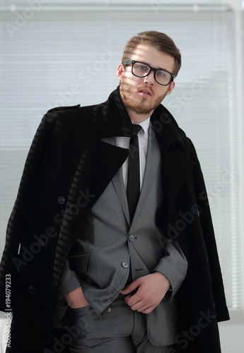 portrait of serious businessman in black coat
