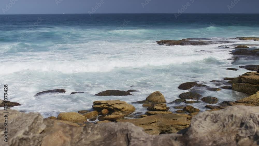 Waves crash against rocks at a section of Bondi Beach Waves crash against rocks at a section of Bondi Beach
