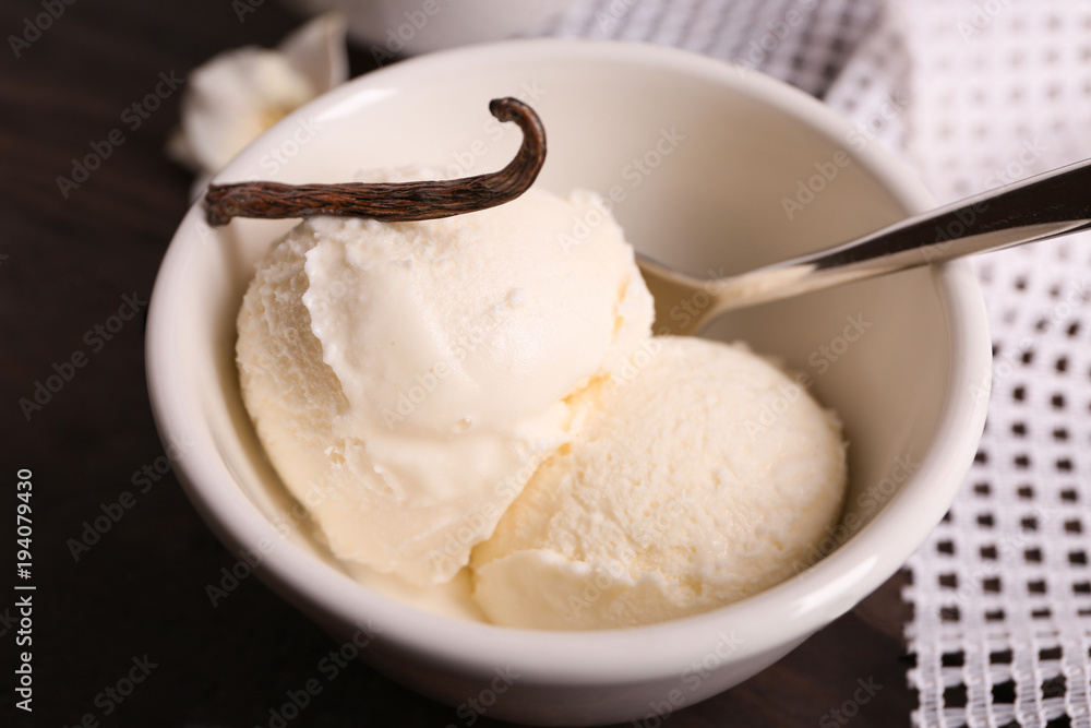 Bowl with delicious vanilla ice cream on table, closeup Bowl with delicious vanilla ice cream on table, closeup
