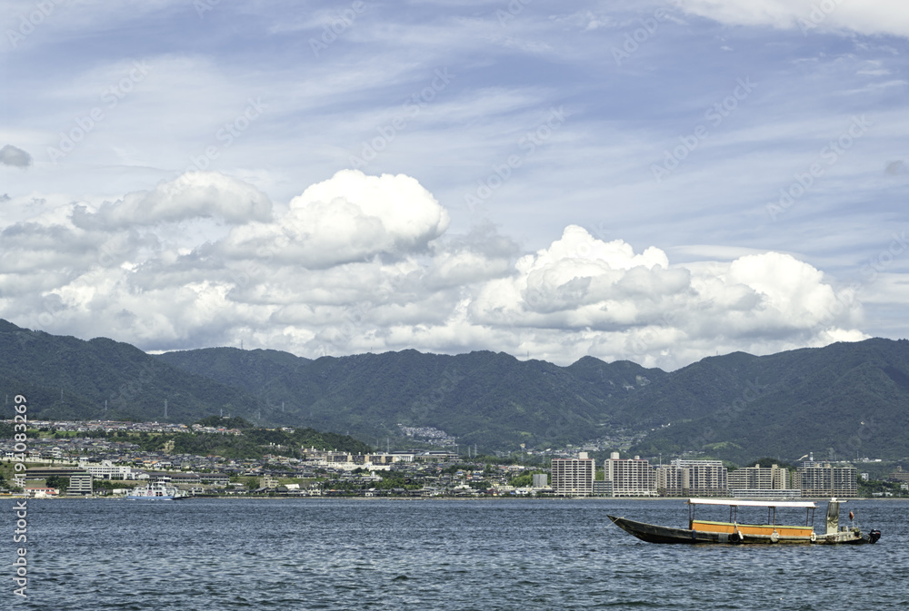 Traditional old Japanease boat in the water in front of Miyajima island, in Hiroshima bay, Japan.