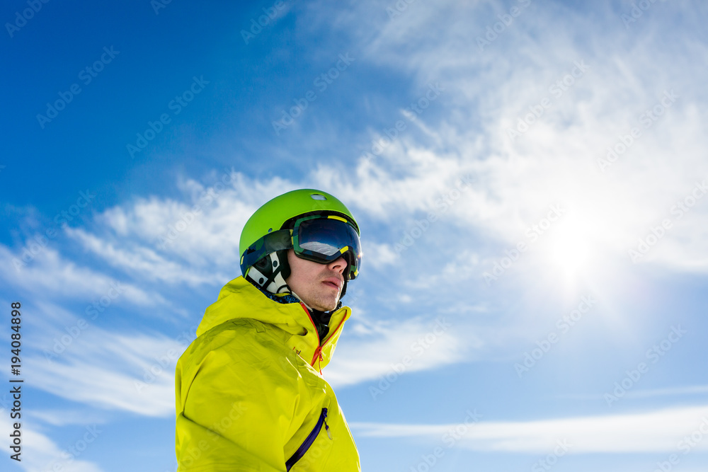 Photo of sporty man wearing mask and helmet against blue sky Photo of sporty man wearing mask and helmet against blue sky