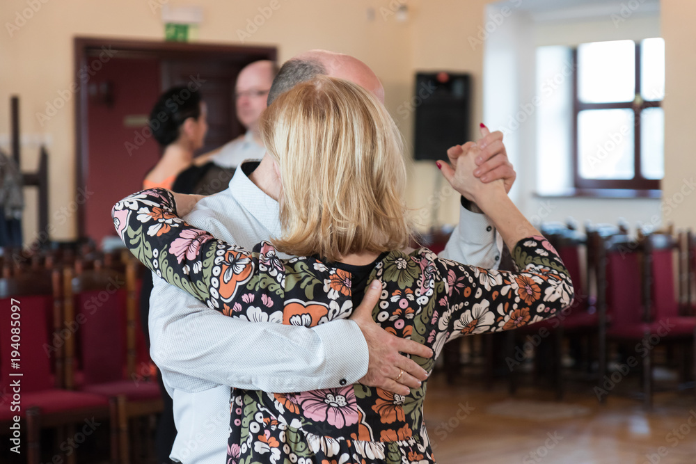 Couple dancing Argentine tango in close embrace