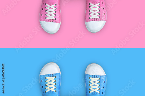 Minimal concept of life. Blue and pink shoes standing on different floor. Think different, opposite, rival, enemy
