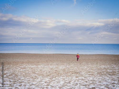 Child on the baltic seaside in winter