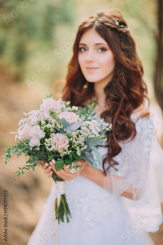 portrait of beautiful bride with a bouquet . looking at the camera.