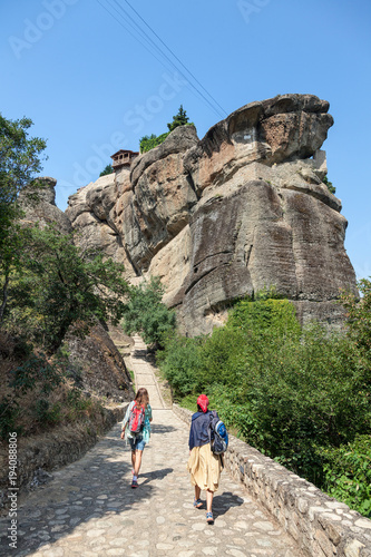 Two female tourists take a walk on the Meteora monasteries, Greece.