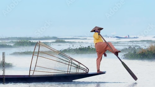 Inle Lake intha fisherman rowing boat in traditional style at sunrise, Shan State, Myanmar (Burma).