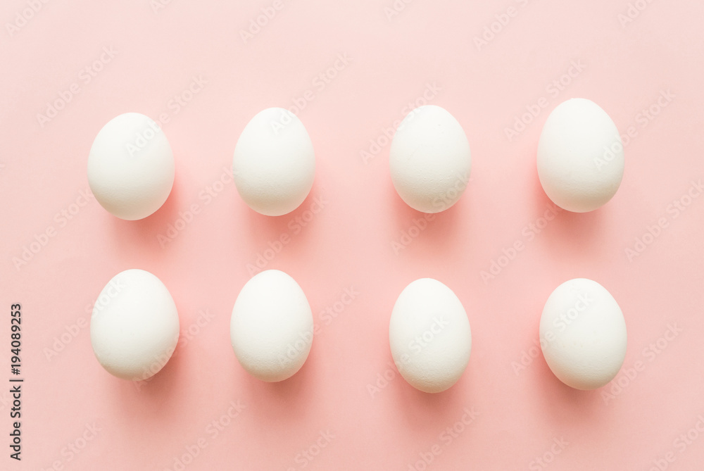 A lot of white eggs on pink pastel background. minimal concept. top view A lot of white eggs on pink pastel background. minimal concept. top view