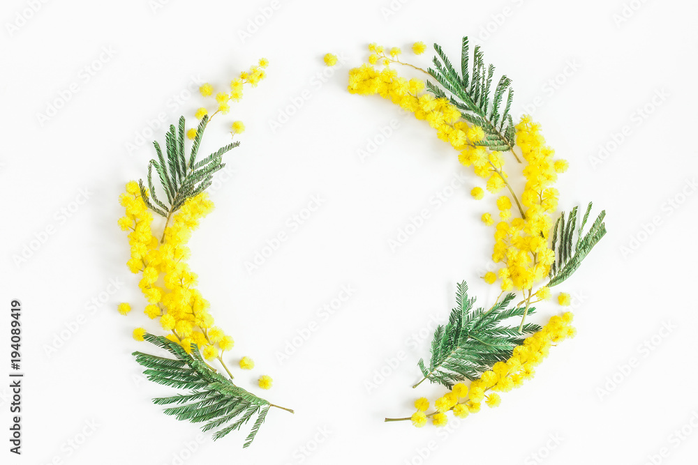 Fototapeta premium Flowers composition. Wreath made of mimosa flowers on white background. Flat lay, top view, copy space