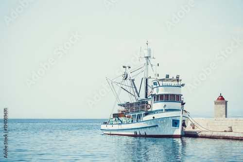 Fishing trawler in the beautiful harbor of a small town Postira - Croatia, island Brac