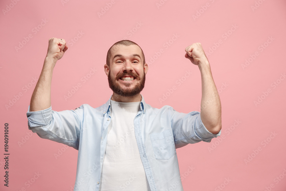 Fototapeta premium Winning success man happy ecstatic celebrating being a winner. Dynamic energetic image of male model