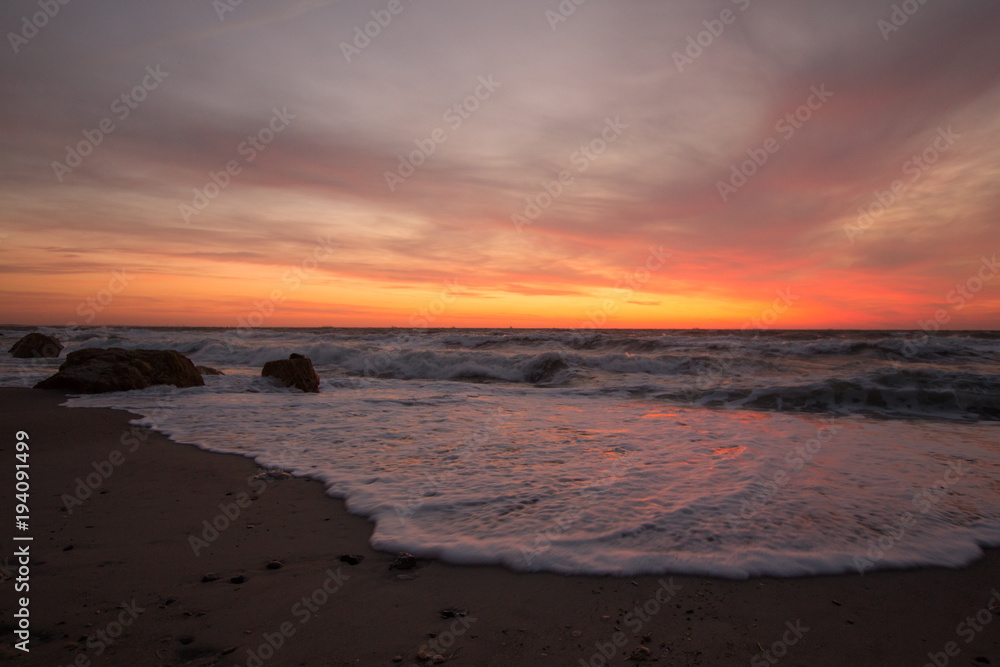 beautiful sea landscape in sunrise time, colorful pink and orange sky and storm in the sea. beautiful sea landscape in sunrise time, colorful pink and orange sky and storm in the sea.