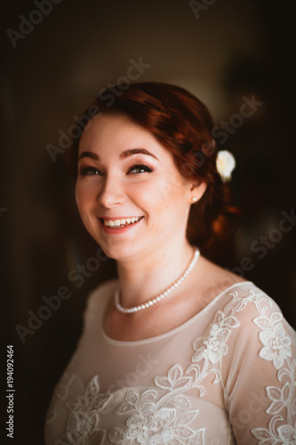 Portrait of a beautiful young bride near the window