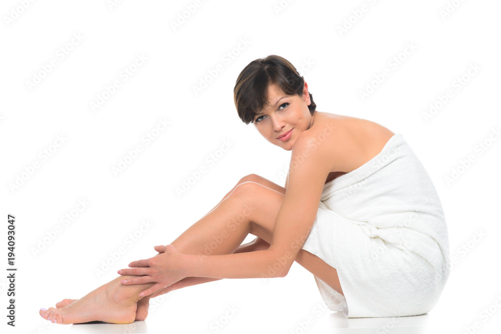 beautiful brunette young woman in towel sitting isolated beautiful brunette young woman in towel sitting isolated