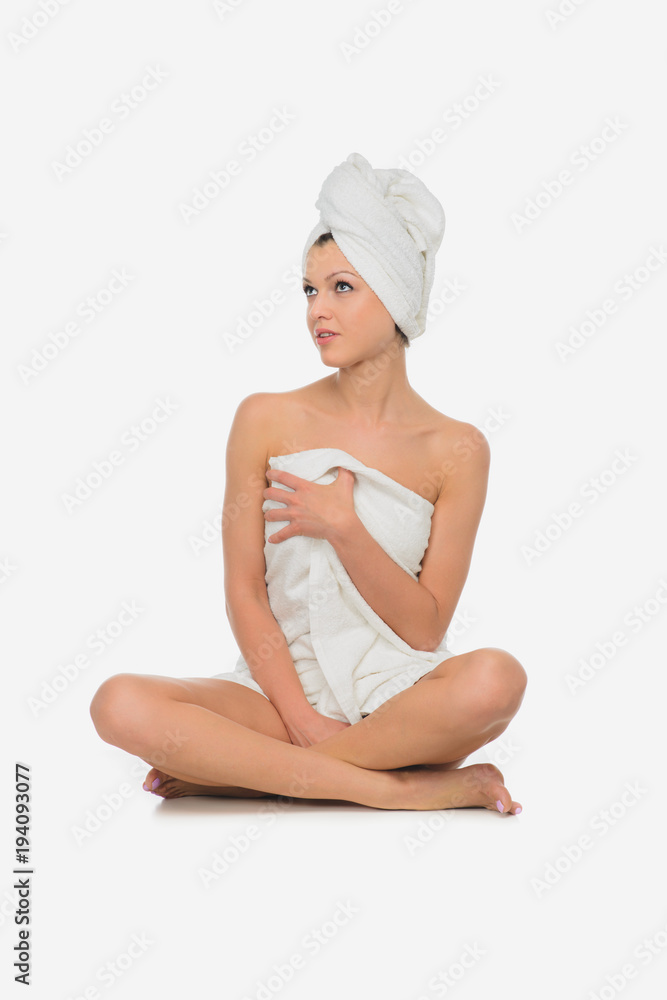 beautiful brunette young woman in towel sitting isolated beautiful brunette young woman in towel sitting isolated