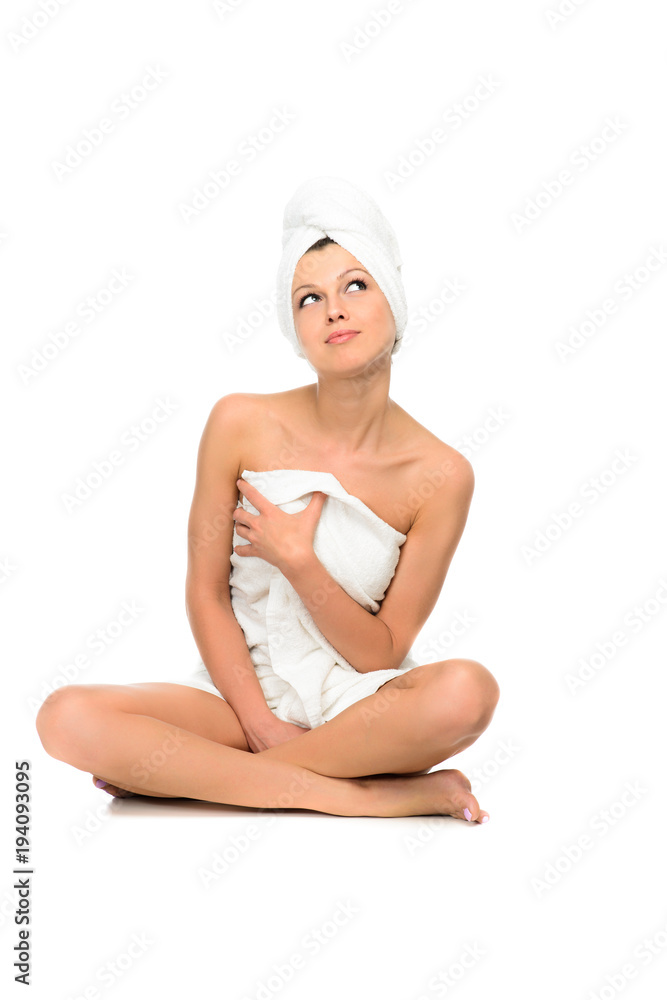 beautiful brunette young woman in towel sitting isolated beautiful brunette young woman in towel sitting isolated
