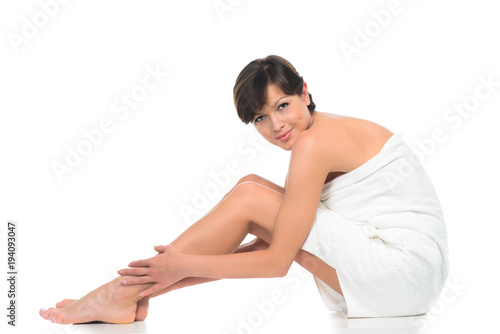 beautiful brunette young woman in towel sitting isolated