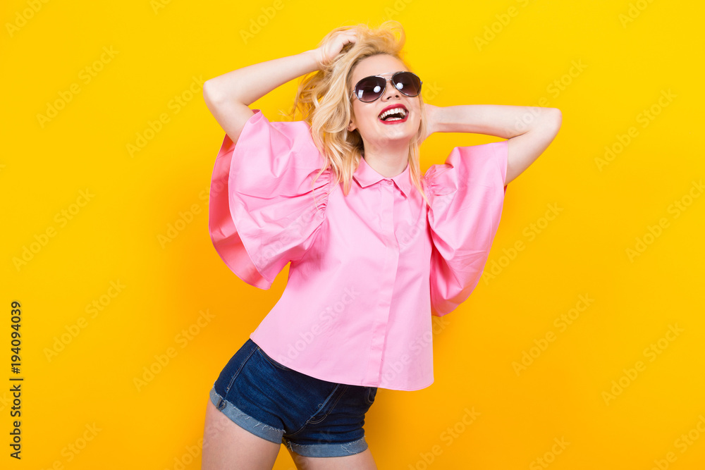 Happy blonde woman in pink blouse with sunglasses Happy blonde woman in pink blouse with sunglasses