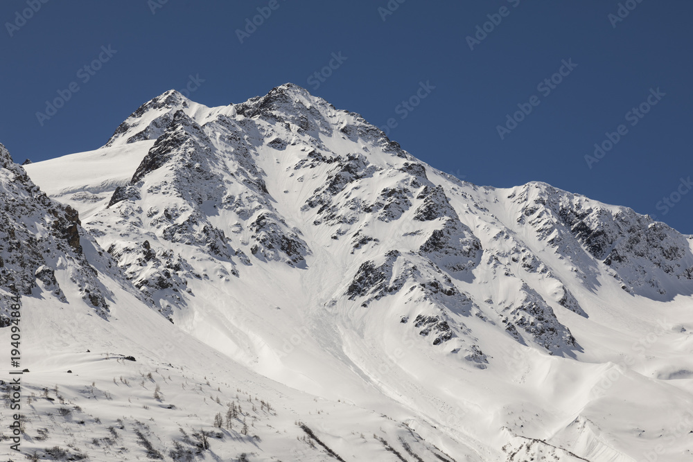 Snow-covered, fresh white mountain peak in the Alps of Switzerland