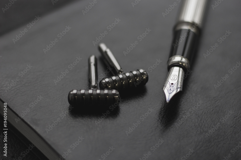 Black style Man set: notepad, pen and cufflinks. Black background Black style Man set: notepad, pen and cufflinks. Black background